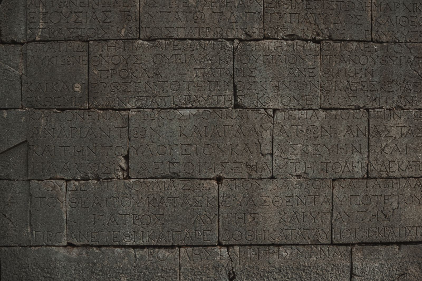 Ancient stone wall with Greek inscriptions engraved on it