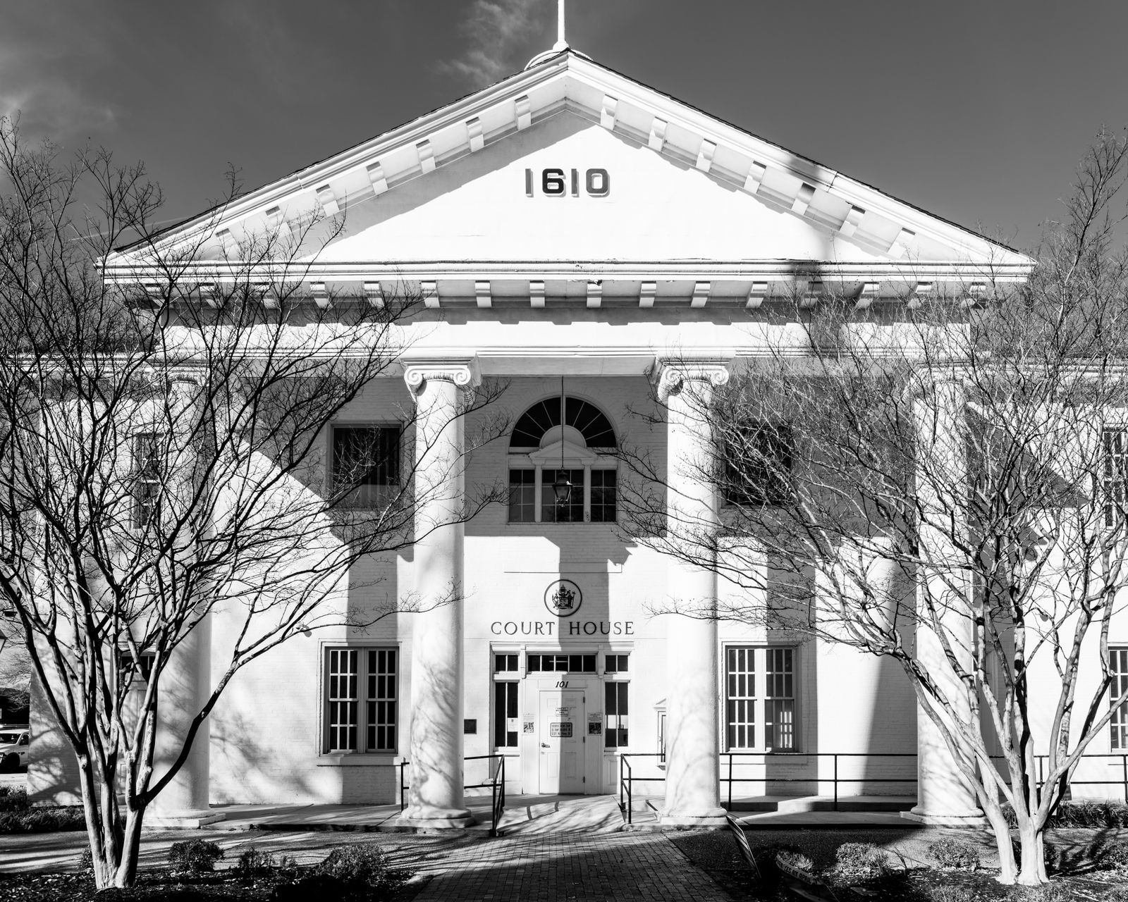 Black and white view of a historic courthouse facade with classical columns
