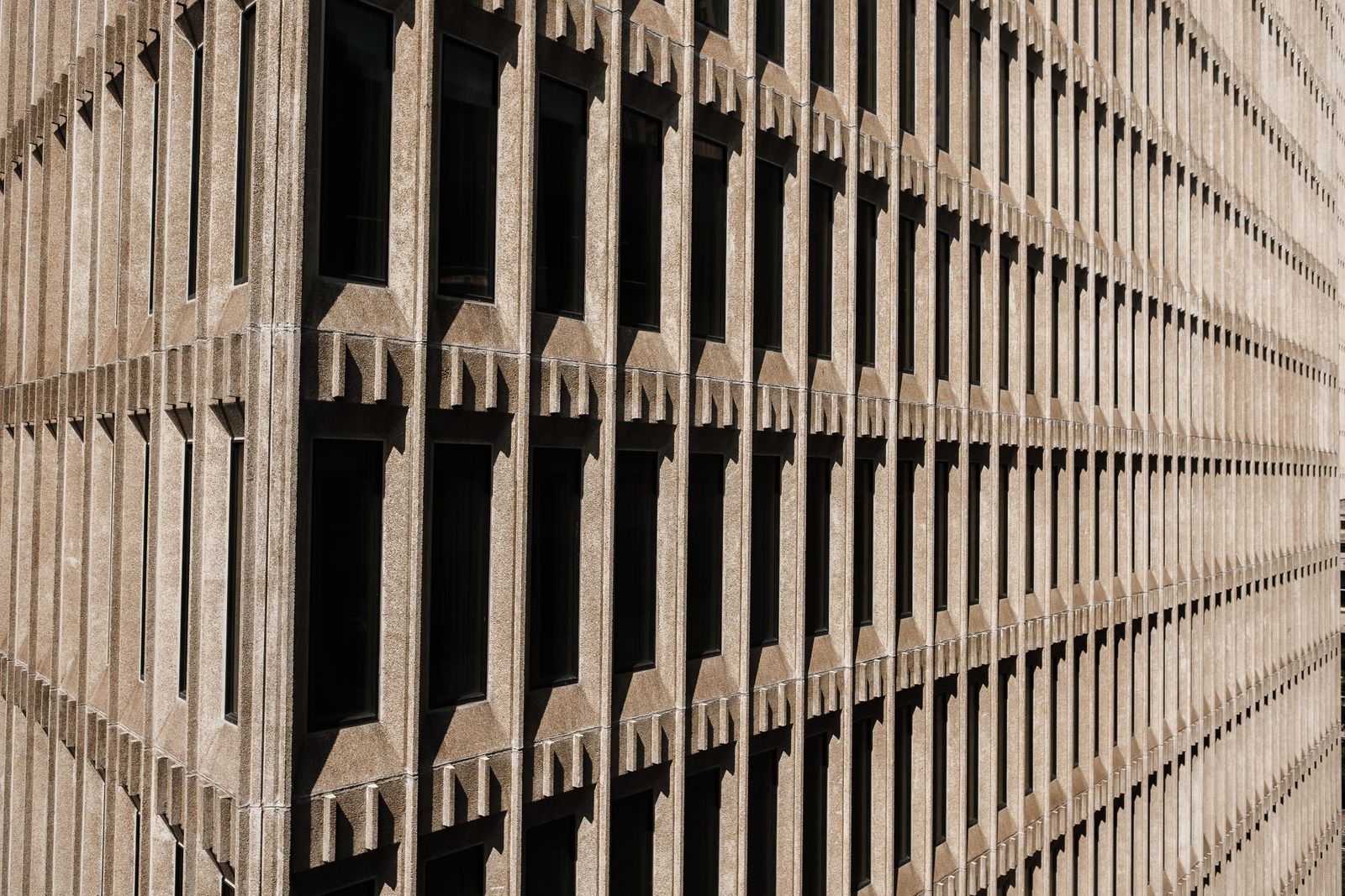 Geometric concrete building facade with light and shadow